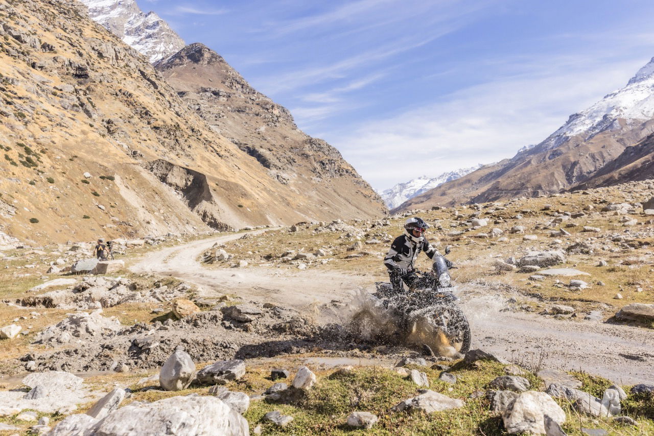 A motorcycle riding through a water splash