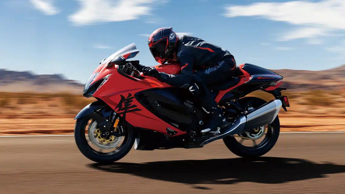 A motorcycle riding along a desert road