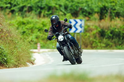 A motorcycle riding around a bend in the road