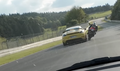 A Ducati Panigale and a Porsche have a close call at the Nürburgring