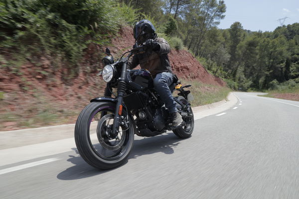 The Guerilla 450 being ridden along a winding road