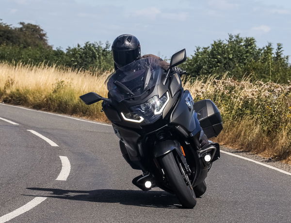 A BMW K1600 B being ridden along a country road