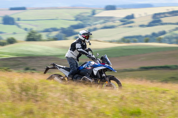 A motorcycle being ridden along a green lane