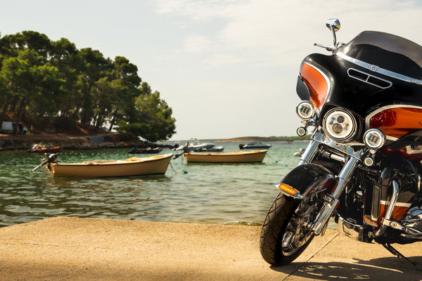 A Harley-Davidson parked next to the sea