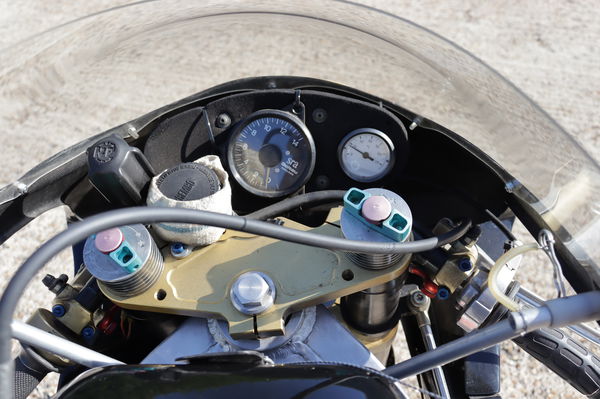 The cockpit of the bike showing the tacho and temperature guage