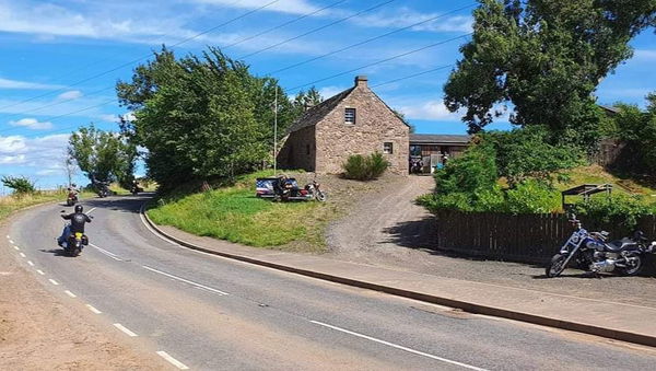 Bikers passing the Davidson cottage in Scotland