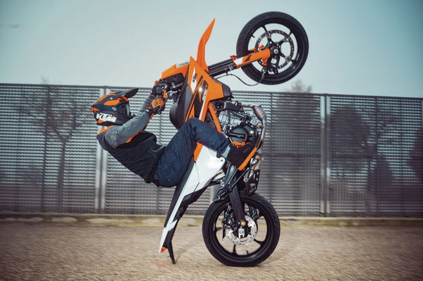 The 2025 KTM 125 SMC R pulling a wheelie