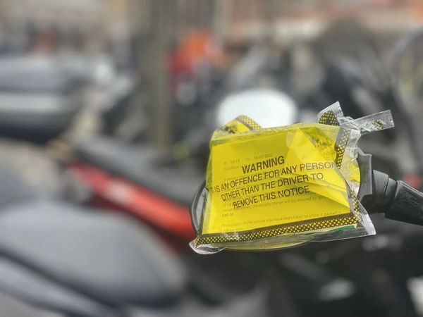A parking ticket on a motorcycle