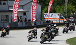 A MiniGP grid heading into a turn. Photo Credit - Larry Lawrence
