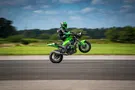JD Stunts pulling a wheelie while seated on the handlebars