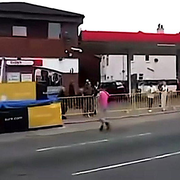 A man crosses the lice TT course during a race