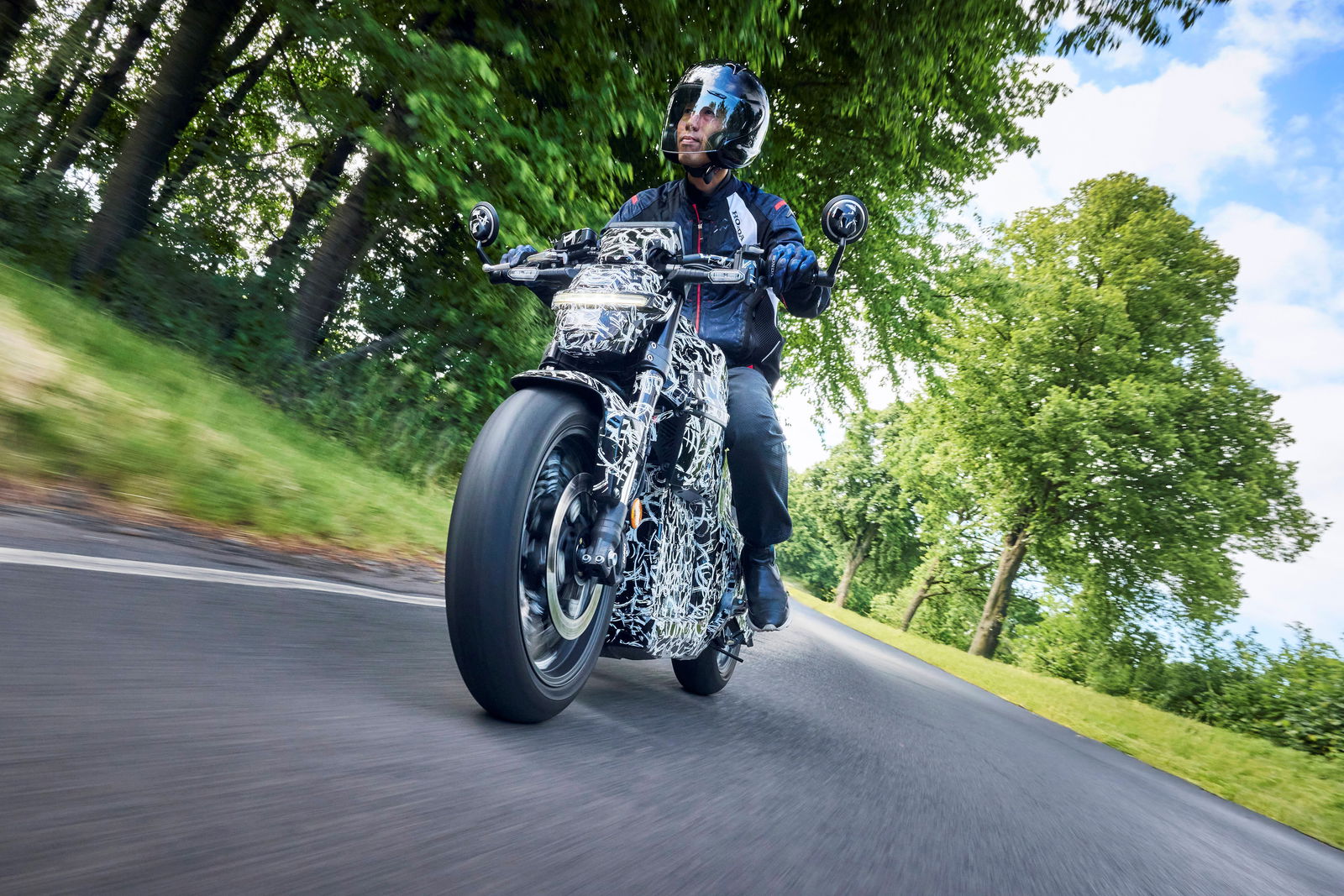 Honda WN7 on the road in a camouflage body