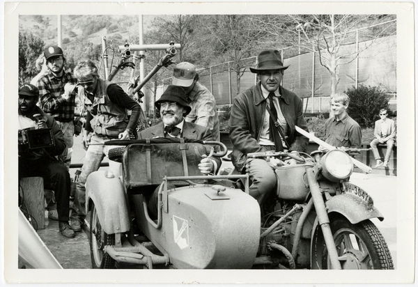Harrison Ford and Sean Connery riding in the sidecar