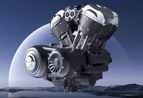 The engine of the bike with the CVT visible (the vented cover) 