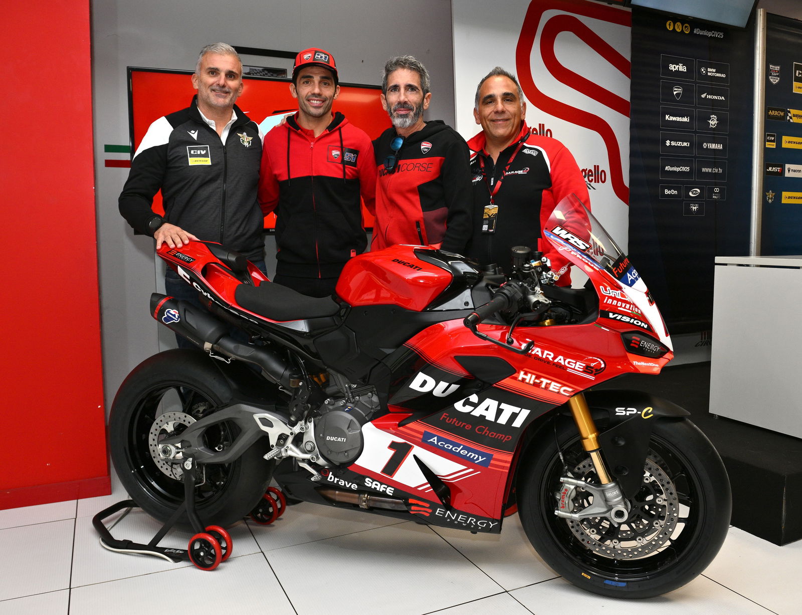 Michele Pirro and other Ducati members standing by a Panigale V2 bike
