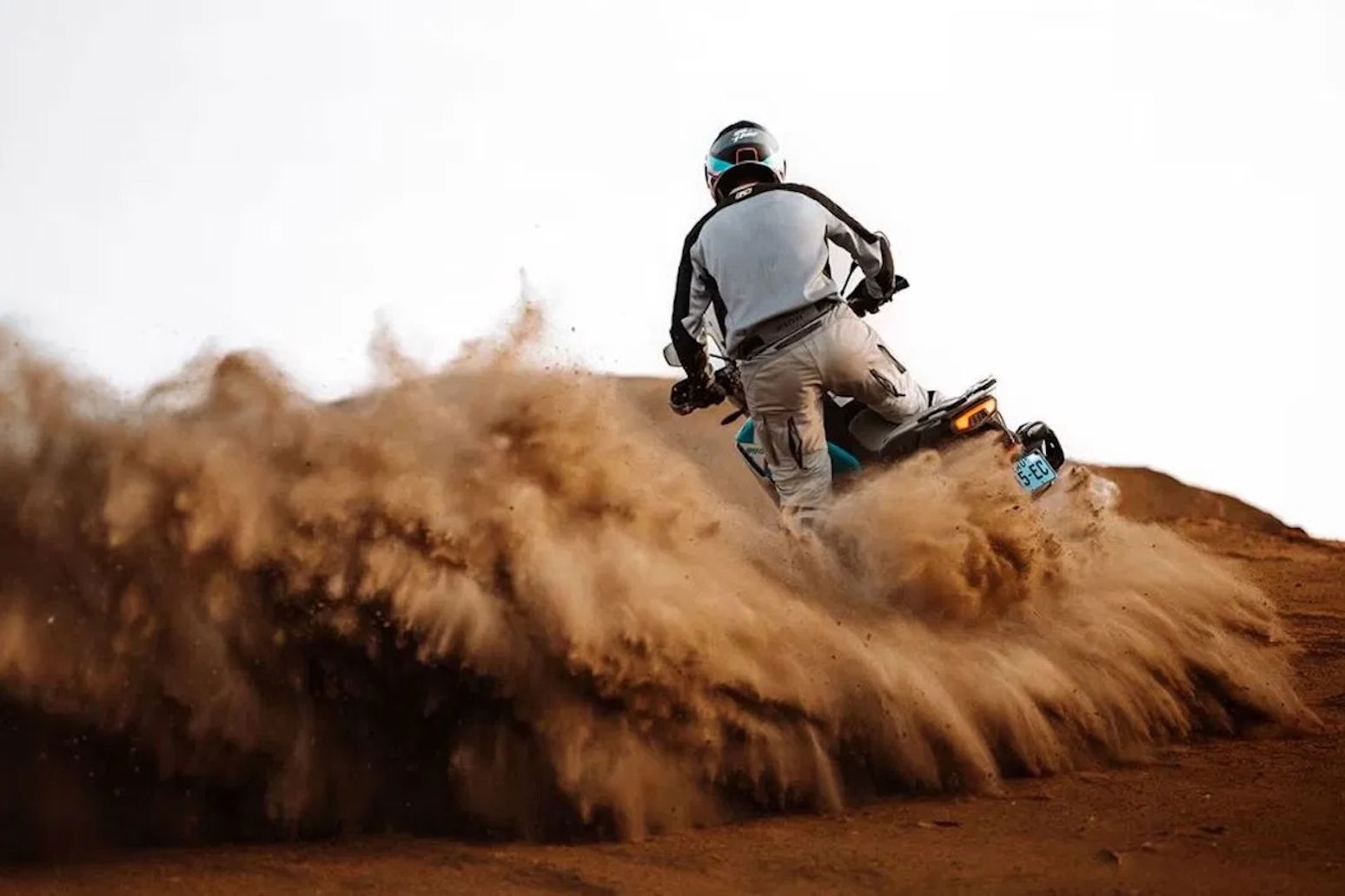 A CFMoto adventure bike riding in the sand