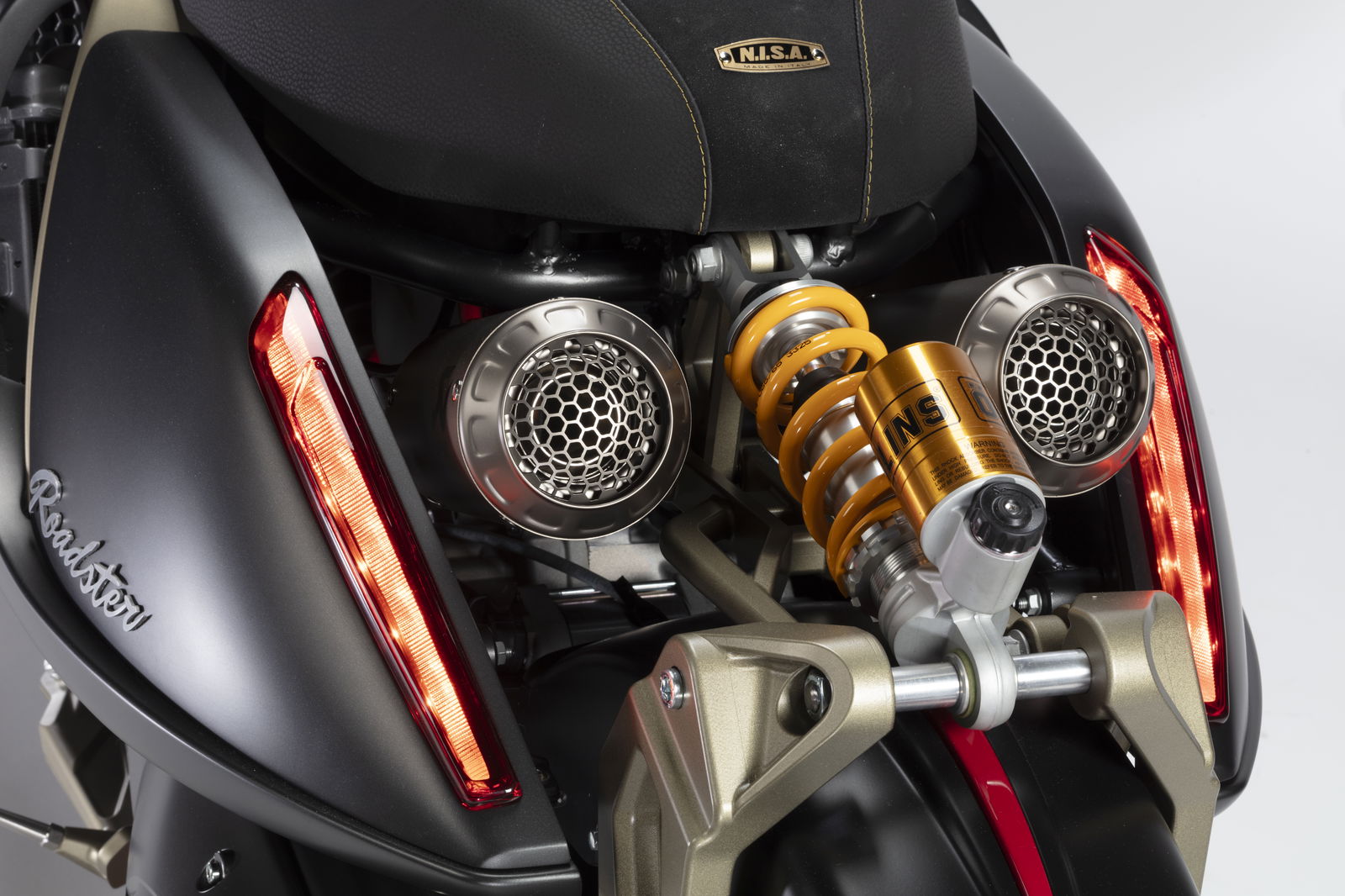 Ohlins suspension sandwiched between Akrapovic exhaust pipes