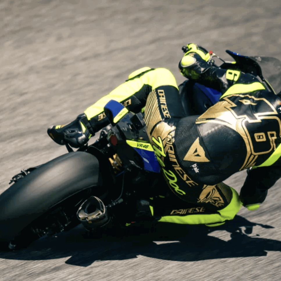 Valentino Rossi wearing a race suit and helmet. Photo credit - Dainese