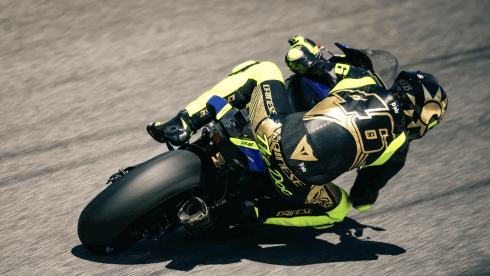 Valentino Rossi wearing a race suit and helmet. Photo credit - Dainese