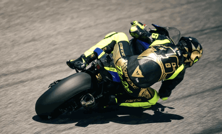 Valentino Rossi wearing a race suit and helmet. Photo credit - Dainese