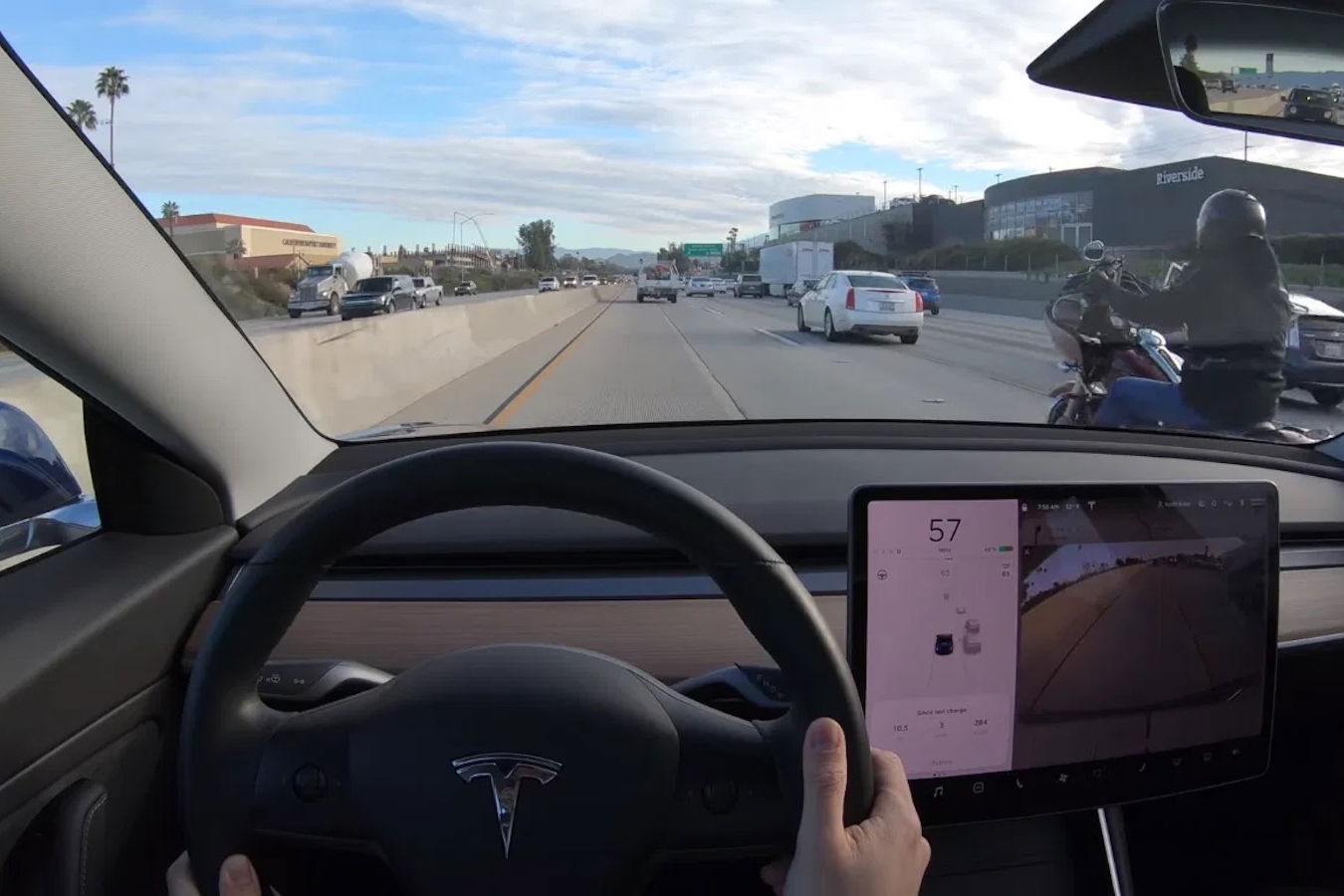 A Tesla driving down the highway