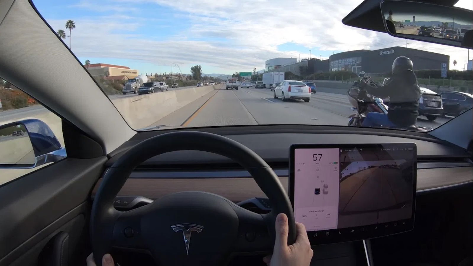 A Tesla driving down the highway