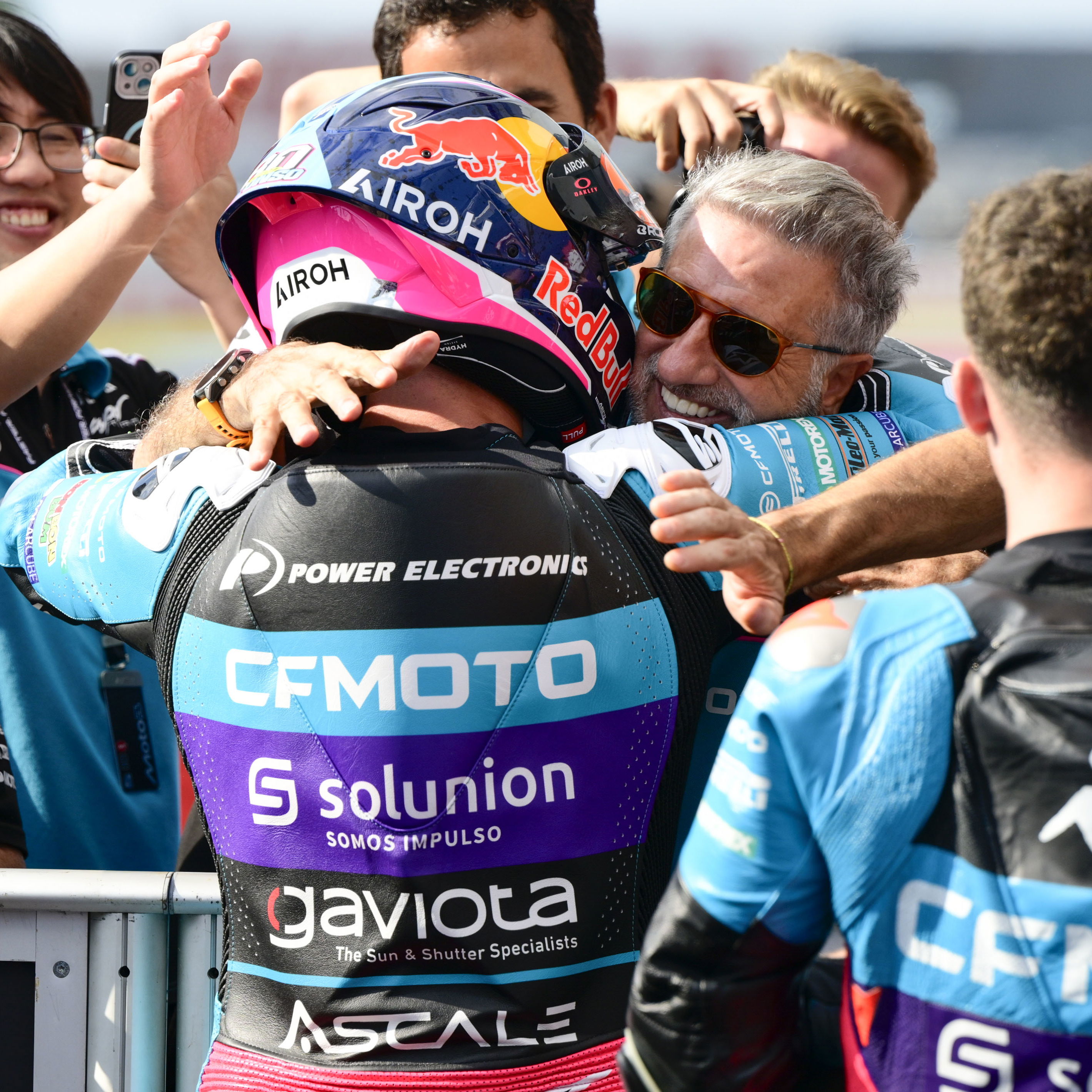 David Alonso hugs Jorge Martinez 'Aspar', 2025 Moto2 Japanese Grand Prix, parc ferme. Credit: Gold and Goose.
