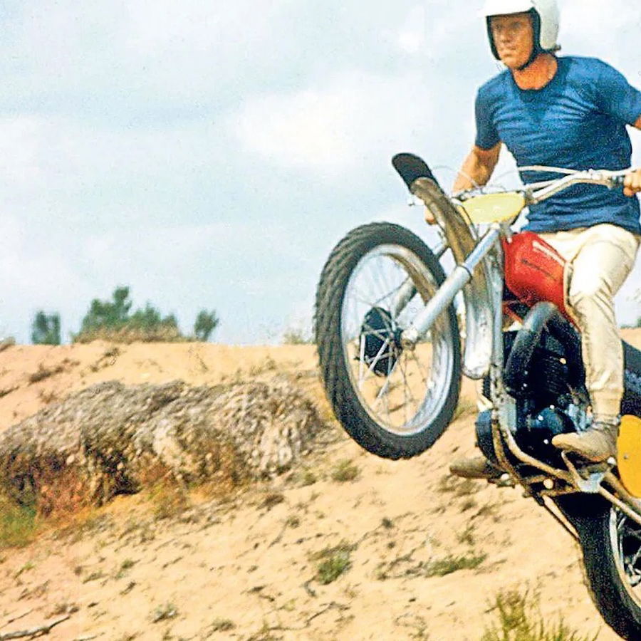 Steve McQueen riding a Husqvarna MX bike in the desert
