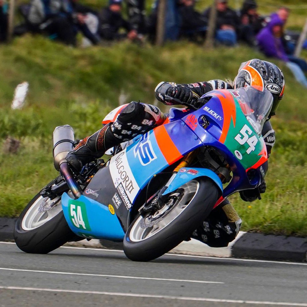 Maria Costello riding a motorcycle at the TT. Photo credit - Iconic Auctioneers
