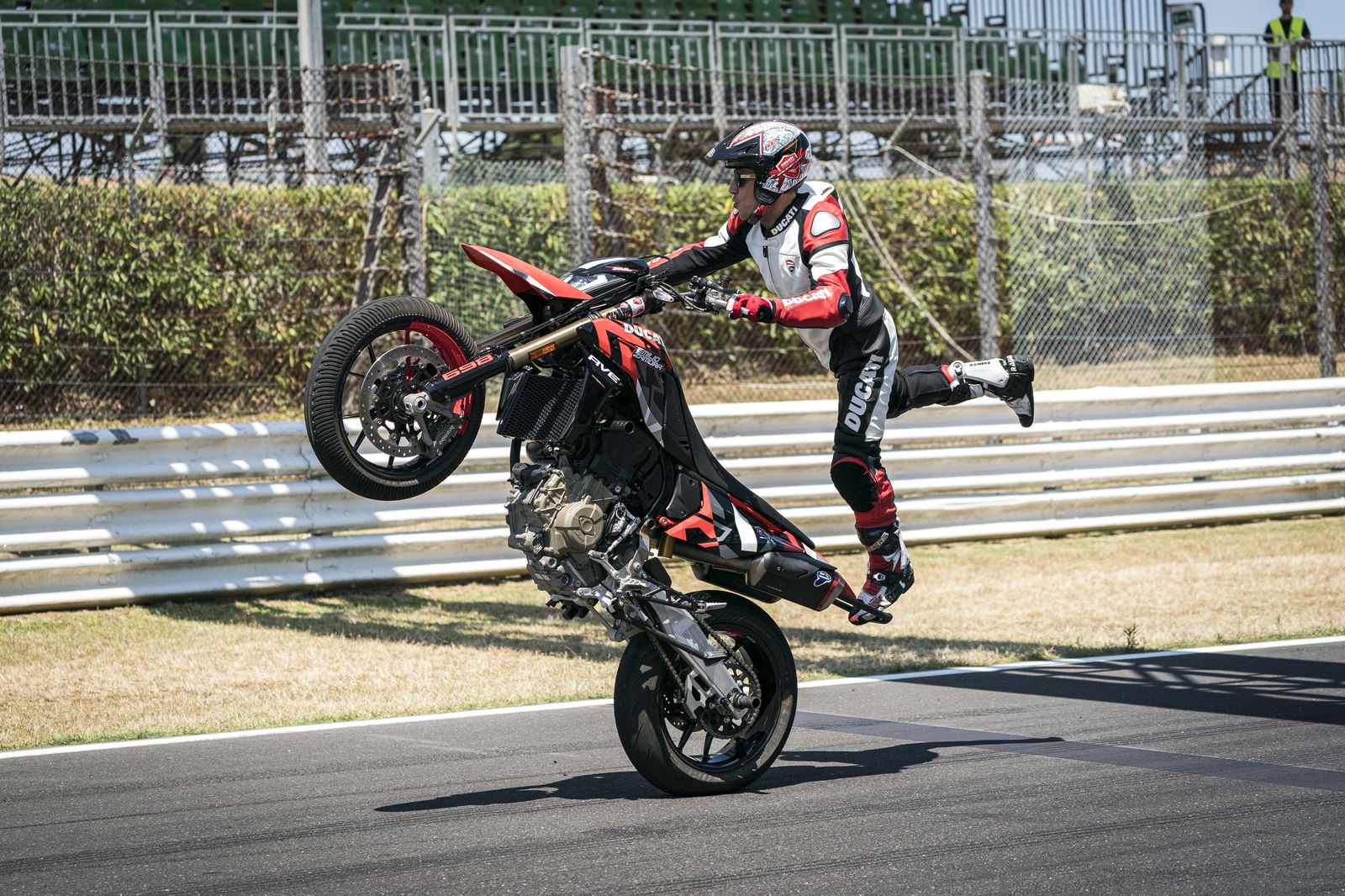 A rider performing a standing wheelie at World Ducati Week