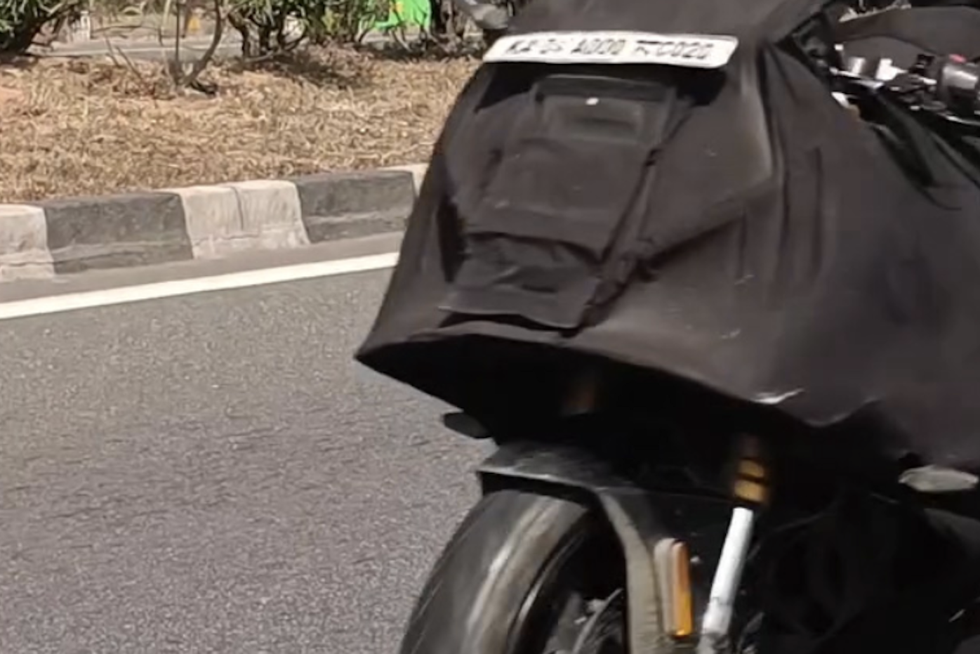 TVS Apache RR 450 under black cover. Credit: Facebook/Bikewale.