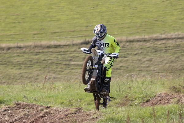 A dirt bike pulling a wheelie