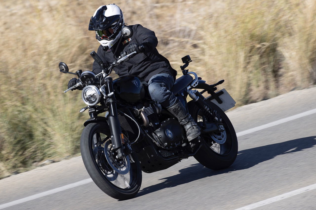 A motorbike being ridden around a bend in the road