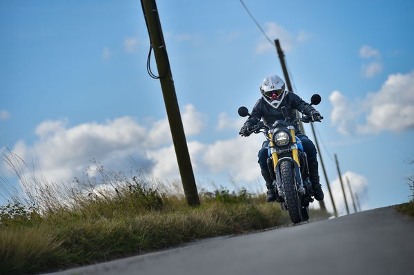 A motorcycle and rider on a country road