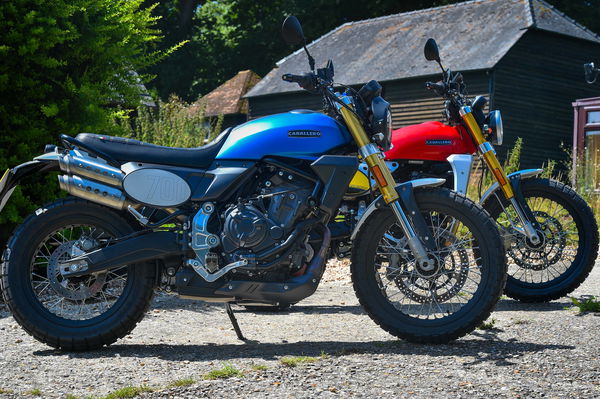 The Fantic Caballero 700 (Blue) and Caballero 500 (Red) parked in a garden