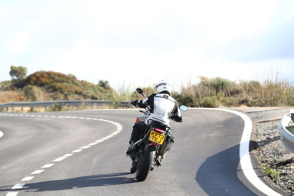 A motorcycle being ridden along a mountain road