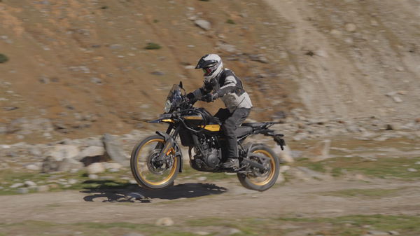 A motorcycle jumping off a rock on an off-road trail