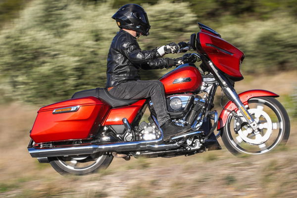 A Harley-Davidson being ridden along a road