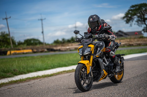 A motorcycle riding along a straight on a racing track