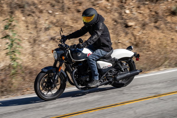 A motorcycle being along a canyon road