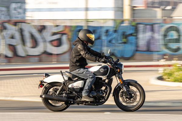 A motorcycle being ridden through an industrial area of LA