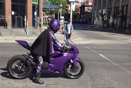Hit Girl rides a purple Panigale