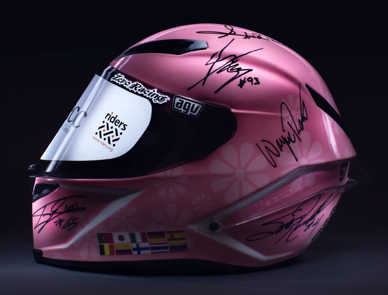 Helmet signed by GP legends makes £200,000 for charity