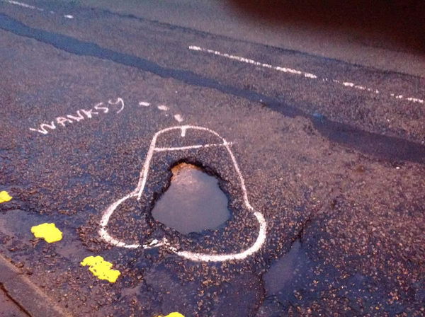 Campaigner highlights potholes by drawing penises around them