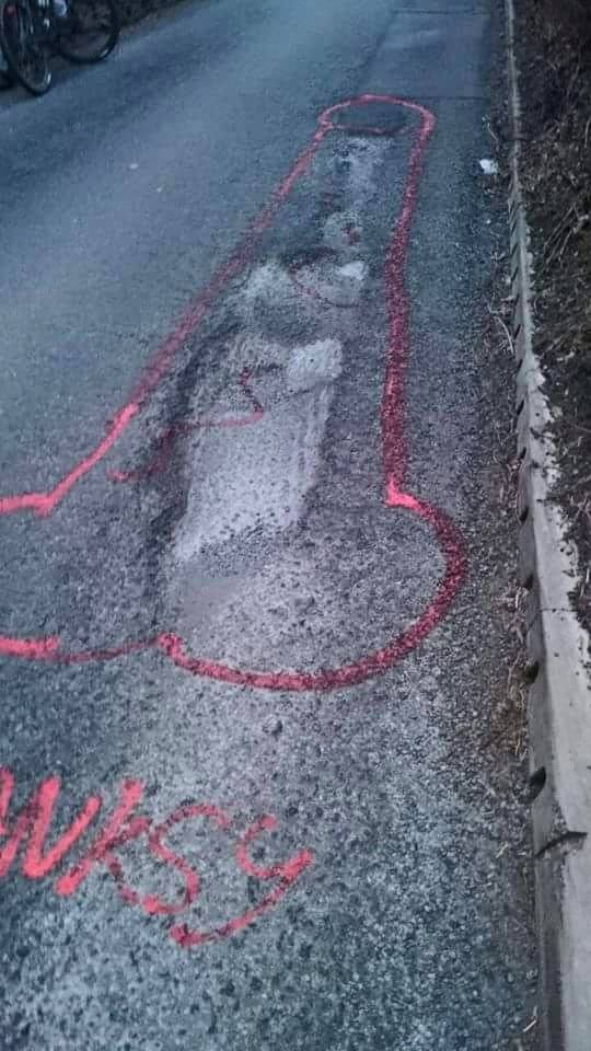 Campaigner highlights potholes by drawing penises around them