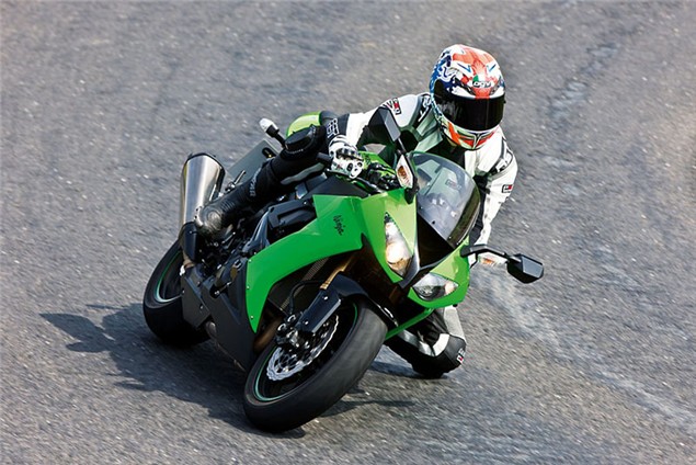 A green 2004 Kawasaki ZX-10R being ridden on a track