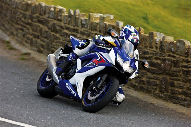 A 2008 Suzuki GSX-R750 being driven around a bend on a country road