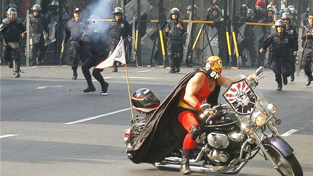 Bike mounted Luchador vs. Mexican riot cops