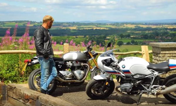 Man stood next to motorcycles