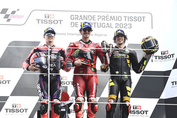 Francesco Bagnaia, Maverick Vinales, Marco Bezzecchi, on 2023 MotoGP Portuguese Grand Prix podium. - Gold and Goose